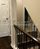 Finished Overland Park Kansas hallway remodel project thats been painted with stairway handrail and new flooring installed
